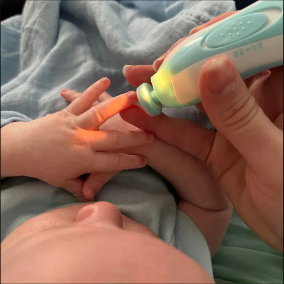 Baby's hand being held by an adult hand with a colorful toy.